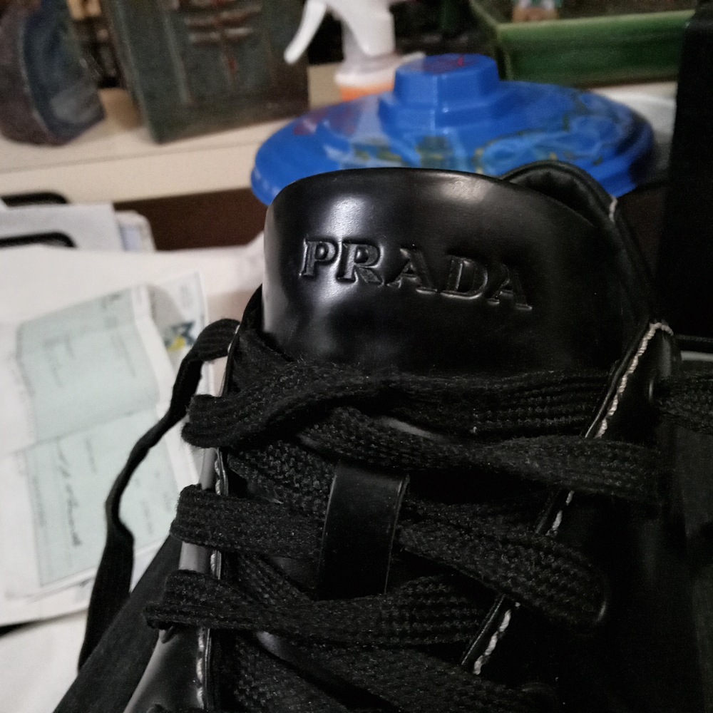 Prada Black Sneakers with Glossy Finish and Metallic Accents - Picture 3 of 7
